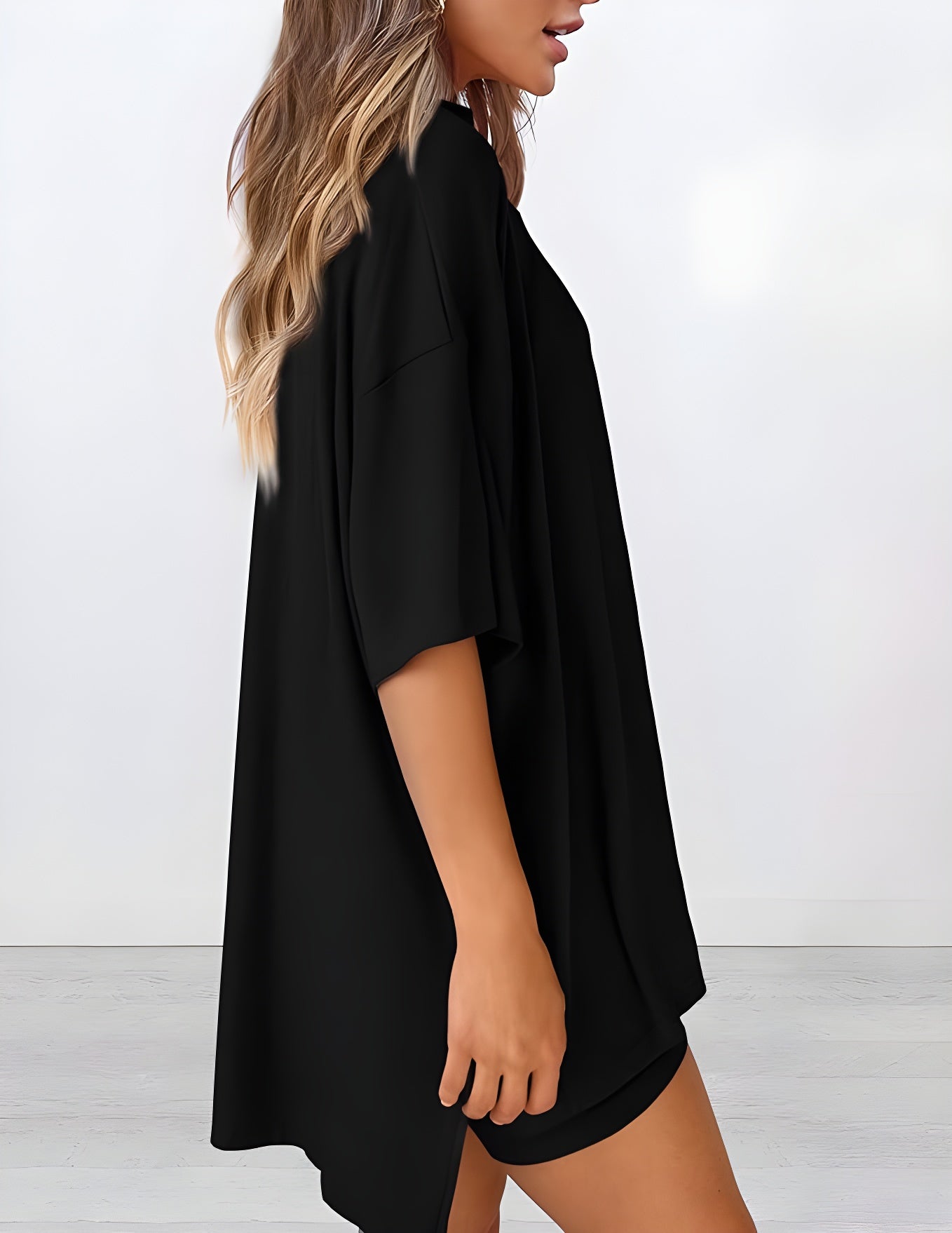Side view of women’s summer loungewear set in black – oversized relaxed fit two piece with t-shirt and shorts