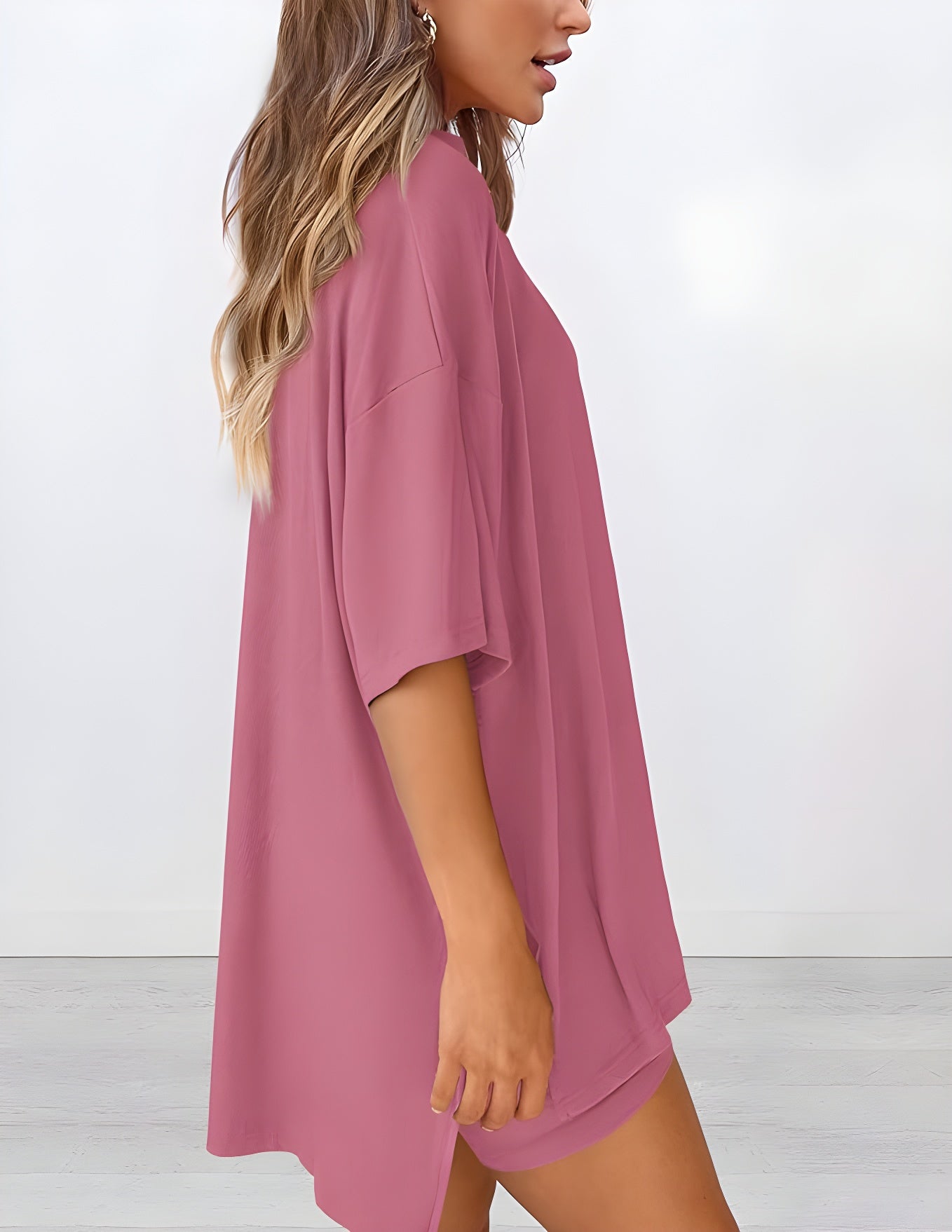 Side view of women’s summer loungewear set in pink – oversized relaxed fit two piece with t-shirt and shorts